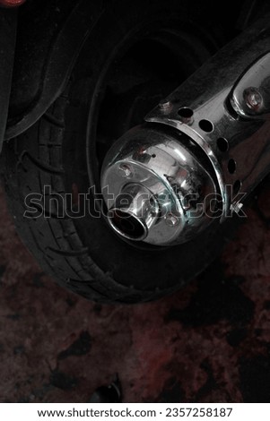 Close up of end of round rusted stainless steel motorcycle muffler dirty exhaust pipe.