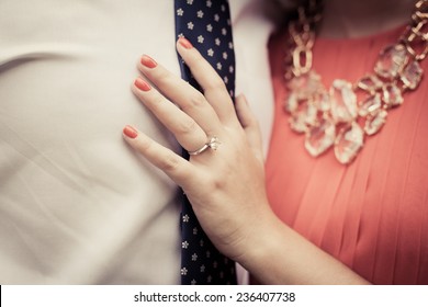 Close Up Of Engaged Couple Showing Diamond Ring 