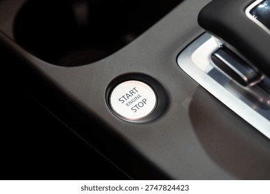 Close up of engine start stop button in car.