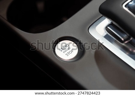 Close up of engine start stop button in car.