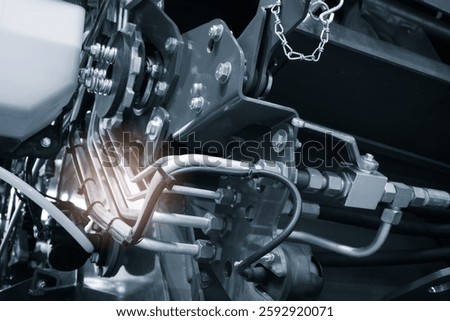 Close up of engine with tank and many tubes and wires, industrial service concept background