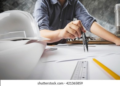 Close Up Of Engineer Hand Sketching A Construction Project With Pencil, Compass.