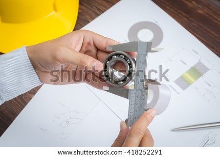 Close up of engineer to measuring bearing by vernier caliper