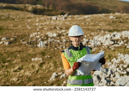 Close up of an Engineer Reviewing Project Papers for the Construction of Wind Turbines 