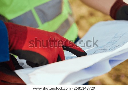 Close up of an Engineer Reviewing Project Papers for the Construction of Wind Turbines 