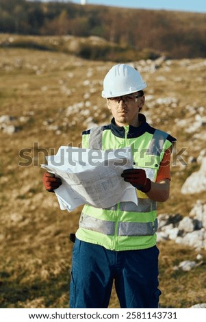 Close up of an Engineer Reviewing Project Papers for the Construction of Wind Turbines 