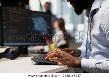 Close up of engineer typing on PC keyboard, coding with AI language model assistance. IT expert writing code, doing software development using artificial intelligence LLM assistant suggestions