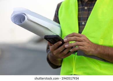 close up engineer using a smartphone in construction site