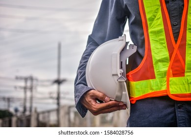 Close Up Engineering Holding White Safety Hard Hat  Standing Out Doors