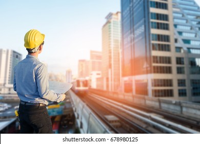 Close up engineers working on a building site holding a blueprints.Engineering and architecture concept - Shutterstock ID 678980125