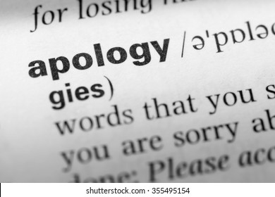 Close up of English dictionary page with word apology