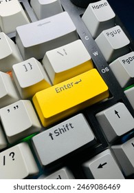 A close up of enter button mechanical keyboard  with light grey, grey, yellow color keycaps
