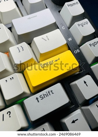 A close up of enter button mechanical keyboard  with light grey, grey, yellow color keycaps
