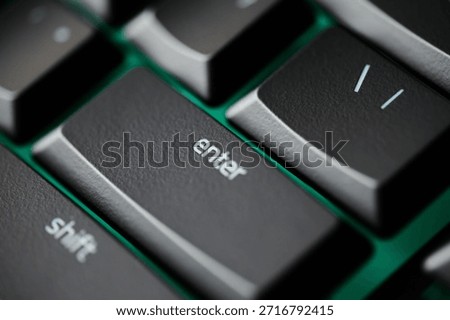Close up of Enter key on mechanical gaming keyboard with green RGB backlight