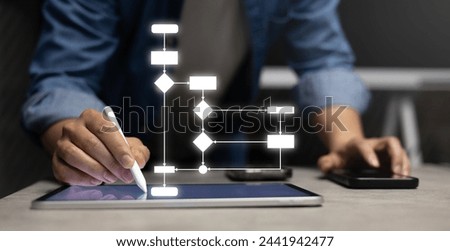 close up entrepreneur businessman hand use stylus pen to write and check about progress or procedure of strategy and resolve with virtual flowchart diagram for business plan and performance concept