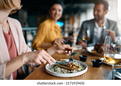 Close up of entrepreneur having business lunch with her coworkers in restaurant. - Powered by Shutterstock