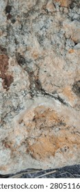 Close up of eroded ancient rock with deep cracks and rough weathered stone texture