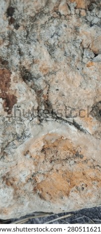 Close up of eroded ancient rock with deep cracks and rough weathered stone texture