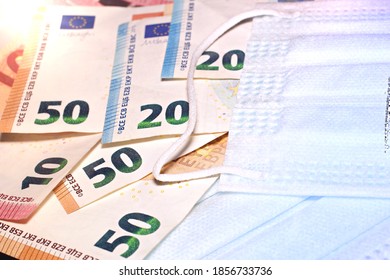 Close Up Of Euro Banknotes With Face Masks Concept Of Corona Virus In Europe