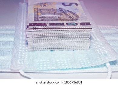 Close Up Of Euro Banknotes With Face Masks Concept Of Corona Virus In Europe