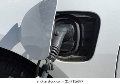 Close Up Of An EV Connector Plug Charging An Electric Car. No People.