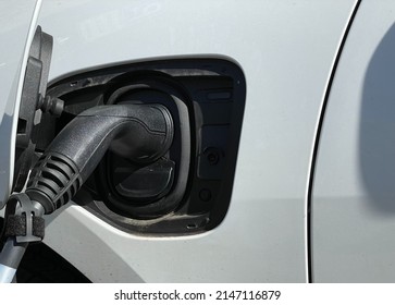 Close Up Of An EV Connector Plug Charging An Electric Car. No People.