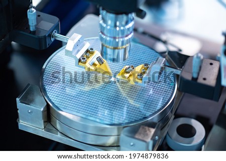 Close up of examining of microprocessor test sample. Microprocessor manufacturing process. Microchip transistor under microscope. Manufacturing of microchips transistor. Microprocessor testing.
