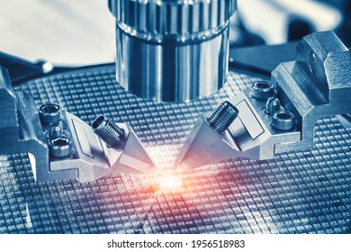 Close up of examining of test sample of microchip transistor under the microscope in laboratory. Equipment for testing microchips. Automation of production. Manufacturing of microchips.