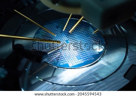 Close up of examining test sample of microchip. Microchip under microscope. PCB transistor in laboratory. Equipment for testing microchips. Testing during PCB production. Manufacturing of microchips.