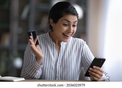 Close Up Excited Indian Woman Holding Credit Card, Using Smartphone, Reading Good News, Checking Balance, Surprised Customer Received Money Refund Or Great Shopping Offer, Making Internet Payment