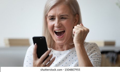 Close Up Excited Older Woman Shouting, Using Phone, Reading Good News In Message, Celebrating Online Lottery Success, Showing Yes Gesture, , Satisfied Client Received Great Shopping Offer