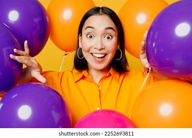 Close up excited surprised shocked impressed happy fun young woman wearing casual clothes celebrating in bunch of balloons isolated on plain yellow wall background. Birthday 8 14 holiday party concept - Shutterstock ID 2252693811