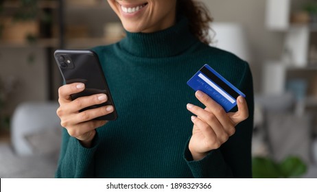 Close up of excited young Caucasian woman hold smartphone shop online with credit card. Happy female client or buyer pay buy on internet with cellphone using secure banking system on gadget. - Shutterstock ID 1898329366