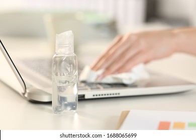 Close Up Of Executive Woman Hands Cleaning Laptop Keyboard With Sanitizer On A Desk In The Office