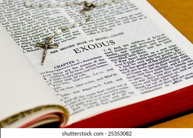 Close Up Of Exodus Bible Page With Rosary