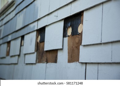 Close Up Of Exterior Suburb House Siding Repair Of Missing Blue Wood Shingles Under Construction Remodeling