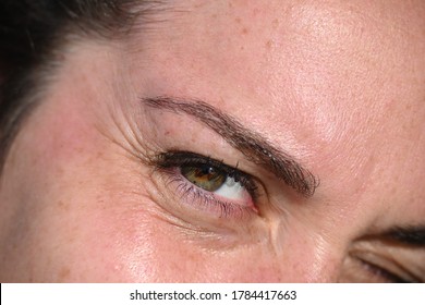 Close up eye with lashes, squinting in the sun