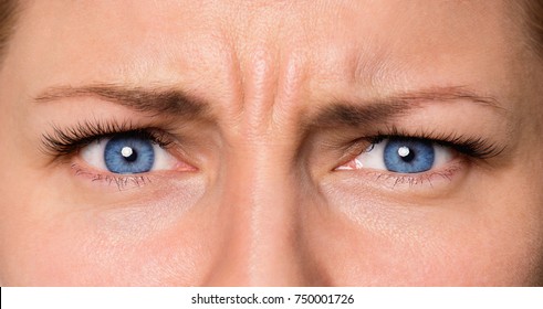 Close Up Eyes Angry Female. Portrait Of Young Woman Expressing Anger, Bad Mood.