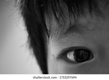 Close Up The Eyes Of Innocent Children With Dripping Sweat With Black And White Effect                             