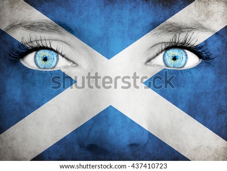 Close up of eyes. Painted face with flag of Scotland
