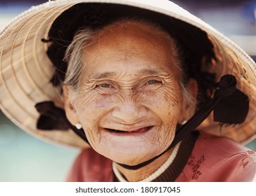 Close up face of beautiful smiling woman with wrinkles. Elderly senior.