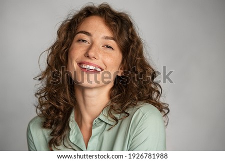 Similar – Close portrait of a young smiling woman with dimples in front of a white wall