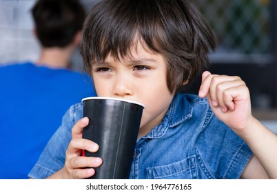 Close Up Face Cute Toddler Boy Drinking Cold Drink, Happy Child Sitting In Cafe Drinking Soda Or Soft Drink From Paper Cup, Unhealthy Drink For Children Concept