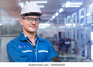 close up face of engineer man worker is standing with confident with blue working suite green reflect for safty dress and helmet in front the glass wall of high technology clean industry factory. - Powered by Shutterstock