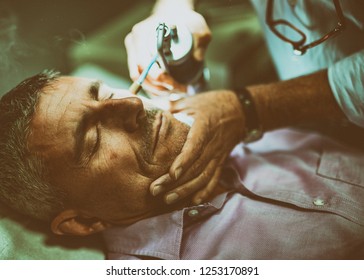 Close Up Of Face Of Man In 50s Receiving Local Cryotherapy. Beauty Treatment Using Vaporized Nitrogen.