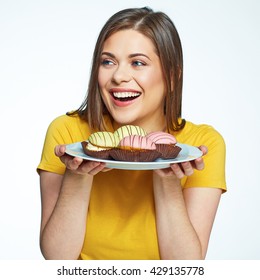 Close up face portrait of happy woman holding plate with macaron cake. French cake. Isolated portrait.