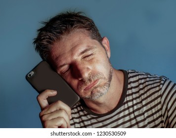 close up face portrait of young attractive and stressed man using mobile phone feeling worried and frustrated in internet social media problem isolated on grey background - Shutterstock ID 1230530509