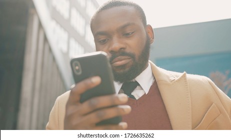 Close Up Face Serious African American Young Attractive Man Use Phone Standing On Street Sunlight Sunset Cellphone Face Outside Technology Businessmen Slow Motion