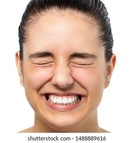 Close Up Face Shot Of Young Woman With Eyes Closed Tensing Eyes. Happy Laughing Girl Isolated On White Background.