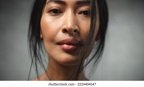 Close Up of the Face of a Strong Asian Female Looking at Camera and Smiling. Proud Woman Fighting Against her Fears and Winning Against Injustice, Prejudice, Mental Illness - Powered by Shutterstock